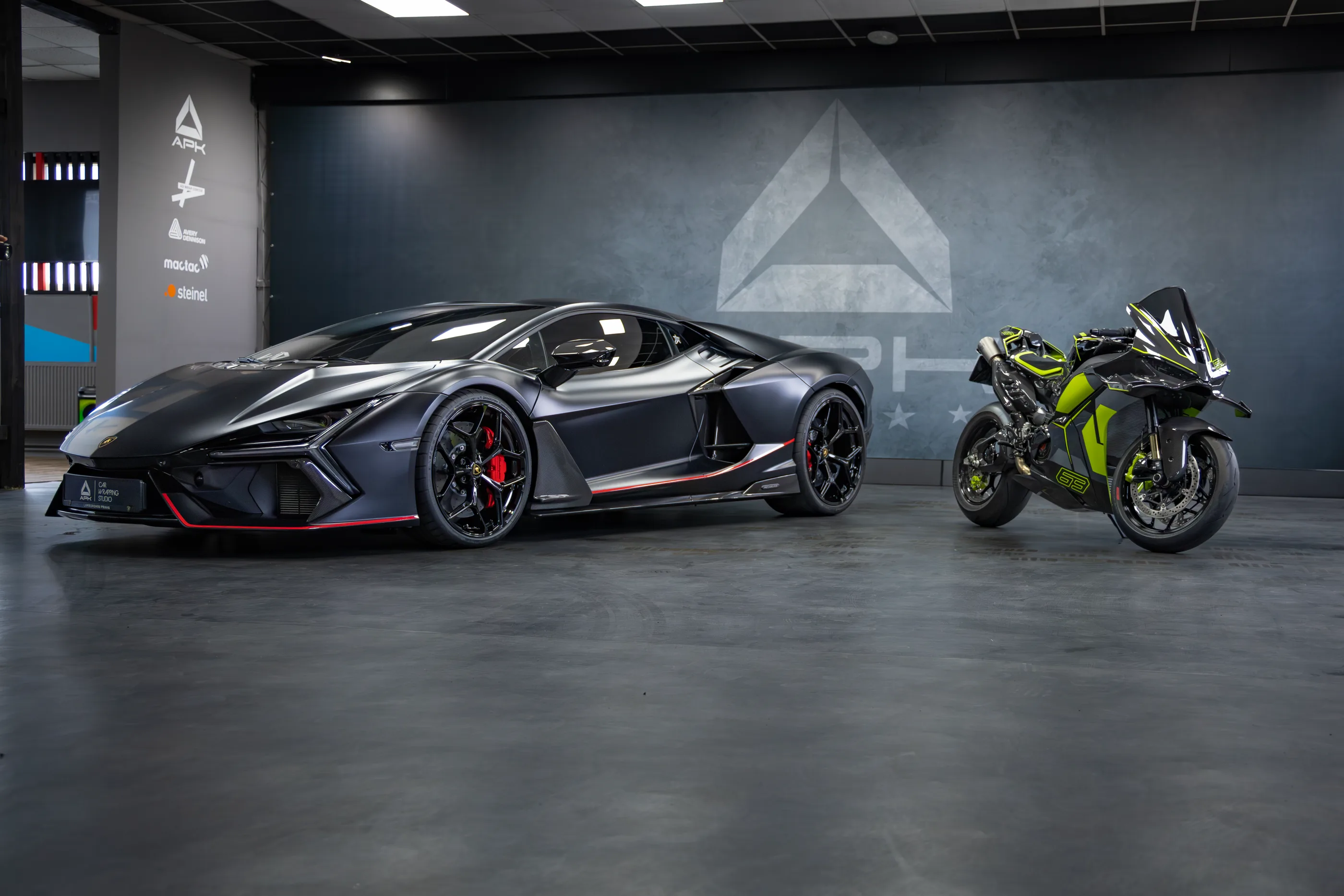 A Lamborghini Revuelto and a motorcycle in the Adwrap Center Kolín studio